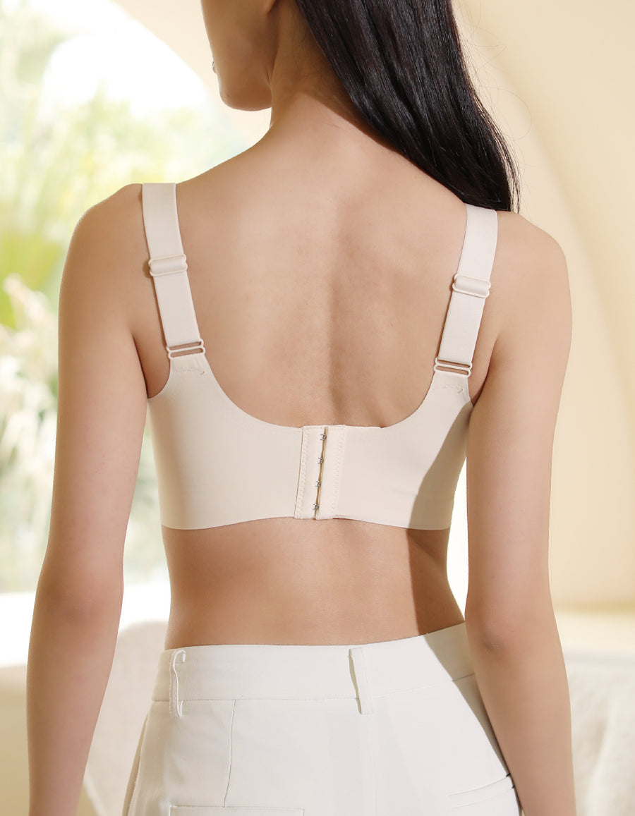Back view of a model wearing Chantelle's Secret Seamless Skin-Toned Bra with adjustable straps and a secure hook-and-eye closure for a smooth, supportive fit.